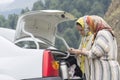 Two Muslim woman making tea at backside of car